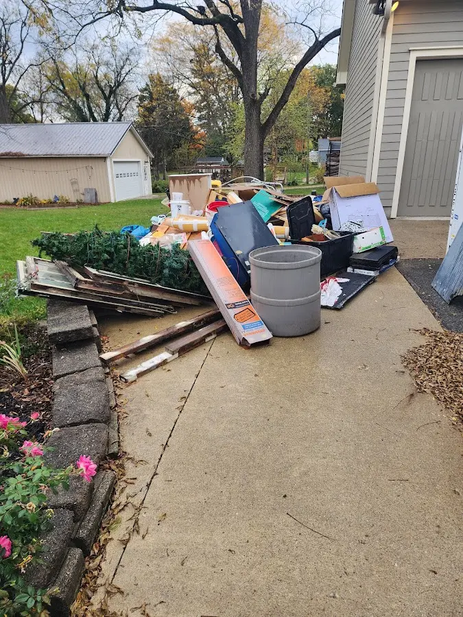 Dumpster being loaded with debris for Roofing Dumpster Rental in Prairie Heights